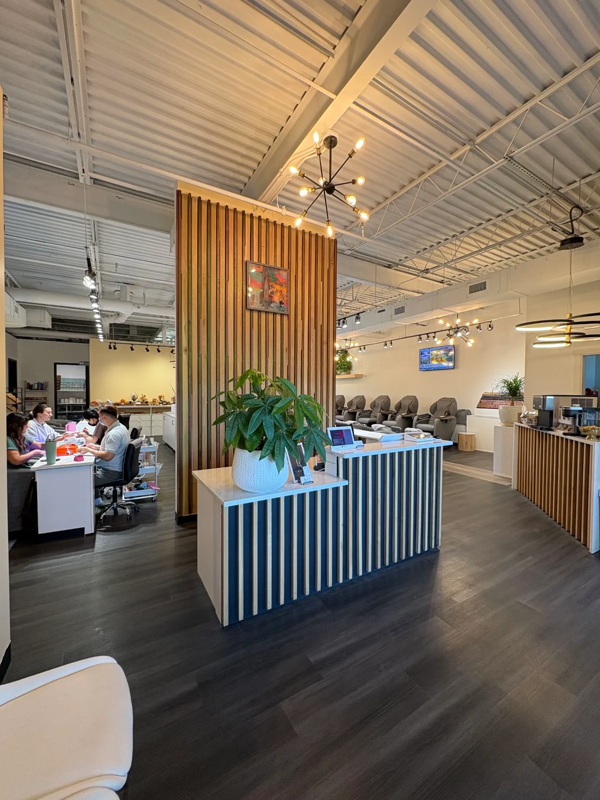 Inside HighEnd Nails Spa: front desk, nail stations and pedicure chairs